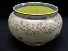 A Wedgwood pottery bowl with rice pattern border, the inside with gilded bird catching a fish.