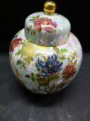 A Willow ware lustre ginger jar and cover decorated with chrysanthemums on a mottled pink ground.