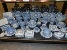 A collection of Wedgwood blue jasper ware, covered boxes, candlesticks, pin trays covered boxes,