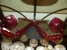 A pair of cranberry glass ornamental large pipes with white overlay to the rims. height 43cms.