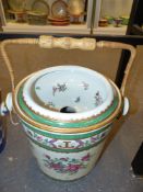 A large German porcelain covered pail decorated in the famille rose manner with polychrome flowers