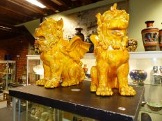 A pair of late 19th Century yellow glazed pottery vases in the form of mythical griffin with incised