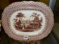 An antique Staffordshire brown transfer printed Zoological pattern meat plate The Rhinoceros. 34cm