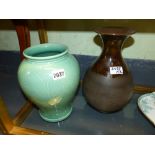 Two Wedgwood pottery studio vases, a baluster example in pale green with incised scrolling leaf