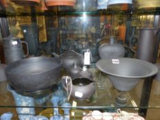 A group of Wedgwood black basalt pieces to include bowls, tea pots, jugs, etc