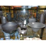 A group of Wedgwood black basalt pieces to include bowls, tea pots, jugs, etc