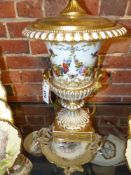 A large Paris porcelain twin handle urn, polychrome floral and bird decoration with gilt accents.