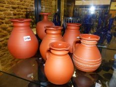 Five various terracotta pottery Wedgwood ale jugs and a similar baluster vase