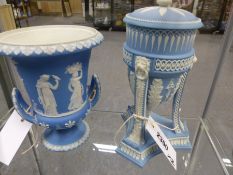 An antique Wedgwood blue Jasper ware covered urn with scrolling supports on shaped triangular