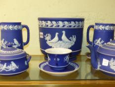 A group of Wedgwood blue Jasper ware bird decorated articles to include a jardiniere. 18.5cm high, a