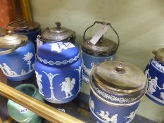 A group of seven blue jasper ware biscuit barrels of various designs most with metal mounts and