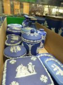 A collection of Wedgwood blue Jasper ware covered boxes of various shapes and sizes, two pairs of