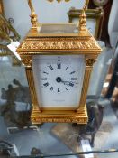 A GOOD QUALITY VICTORIAN STYLE BRASS CARRIAGE CLOCK BY TAYLOR & BLIGH.