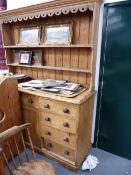 A LARGE VICTORIAN PINE DRESSER THE BASE WITH CENTRAL CUPBOARD FLANKED BY EIGHT DRAWERS WITH PINE AND