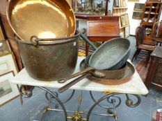 A LARGE 19TH.C.COPPER TWIN HANDLED PAN, THREE LARGE SHALLOW COPPER PANS AND A SWING HANDLED COPPER