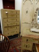 A VINTAGE PAINTED BEDROOM SUITE WITH FLORAL DECORATION COMPRISING A SIX DRAWER TALL CHEST, A FOUR
