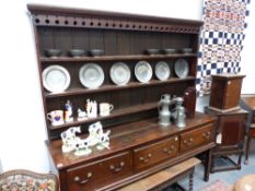 AN 18TH.C.OAK DRESSER BASE WITH THREE DRAWERS ON SQUARE LEGS AND PLATE RACK OVER.