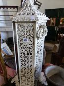 AN ANTIQUE CAST IRON VERITAS STOVE NOW FITTED WITH A LAMP