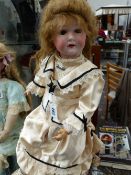 BELIEVED TO BE C.C. BERGMAN 16 DOLL WITH BROWN EYES, OPEN MOUTH AND COMPOSITION BODY. 59cms LONG