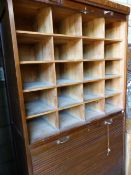 A LARGE PINE TAMBOUR DOOR CABINET WITH PIGEON HOLE INTERIOR