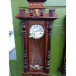 A VICTORIAN MAHOGANY CASED VIENNA WALL CLOCK WITH TWIN WEIGHT DRIVEN STRIKING MOVEMENT.
