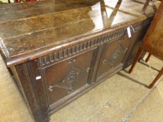 AN 18TH.C.OAK COFFER WITH PLANK TOP OVER CARVED FRIEZE AND CARVED PANELS.