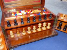 AN EDWARDIAN MAHOGANY CASED GAMED COMPENDIUM.