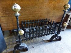 AN ANTIQUE WROUGHT IRON AND BRASS FIREGRATE AND DOGS