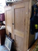 AN ANTIQUE PINE TWO DOOR CABINET WITH PIGEONHOLE INTERIOR