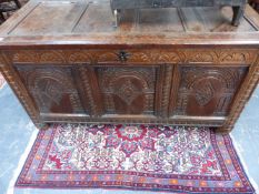 AN EARLY 18TH.C.OAK PANEL COFFER WITH CARVED DECORATION.