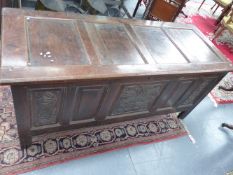 A LARGE 18TH.C.OAK COFFER WITH FOUR PANEL TOP OVER FIVE PANEL BASE WITH CARVED DECORATION.
