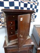 AN ANTIQUE OAK CABINET WITH FITTED DRAWER INTERIOR.