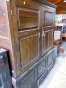 A LARGE 18TH.C.OAK LIVERY CUPBOARD WITH PANEL DOORS OVER A THREE DRAWER BASE