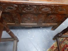 A MID 18TH.C.OAK PLANK COFFER WITH CARVED AND DECORATED FRONT PANELS.