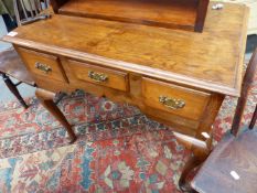 AN ANTIQUE OAK LOW BOY WITH THREE DRAWERS ON LONG CABRIOLE LEGS