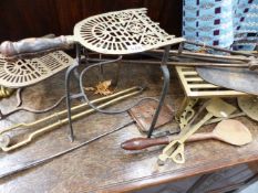 A COLLECTION OF 19TH.C.AND LATER BRASS, COPPER AND IRON FIRESIDE TOOLS AND A BRASS LION'S PAW