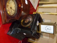 A VICTORIAN BLACK SLATE MANTLE CLOCK, A CARRIAGE CLOCK AND AN EDWARDIAN INLAID DESK CLOCK.