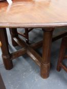 AN INTERESTING ARTS AND CRAFTS OAK AND MAHOGANY DINING TABLE WITH SIX OCTAGONAL LEGS UNITED BY