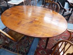 A CONTINENTAL FRUITWOOD OVAL DINING TABLE ON SQUARE TAPER LEGS.