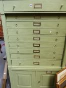 A TALL PAINTED CHEST OF NINE DRAWERS WITH CUPBOARDS BELOW.