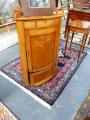 A 19TH.C.SATINWOOD BOW FRONT CORNER CABINET, WITH SMALL DRAWER OVER TWO PANEL DOORS BELOW.
