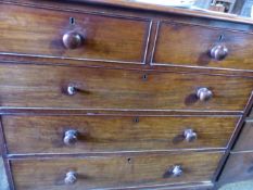 AN EARLY VICTORIAN MAHOGANY CHEST OF DRAWERS ON TURNED FEET