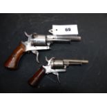 TWO CONTINENTAL PINFIRE REVOLVERS, EACH WITH SIX-SHOT CYLINDER, FOLDING TRIGGER AND TWO PIECE WOODEN