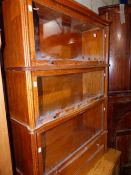 A THREE TIER GLOBE WERNKE BOOKCASE WITH DRAWER BASE