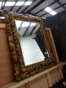 A CARVED GILTWOOD FRAME WITH LATER MIRROR PLATE.