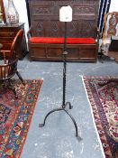 A LARGE FLOOR STANDING WROUGHT IRON PRICKET CANDLESTICK.