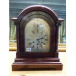 AN EDWARDIAN MAHOGANY CASED BRACKET CLOCK WITH ENGRAVED, SILVERED ARCH TOP DIAL AND THREE TRAIN