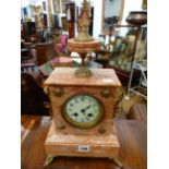 A FRENCH PINK MARBLE CASED MANTLE CLOCK WITH ENAMELLED DIAL AND BELL STRIKING MOVEMENT.