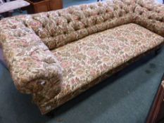 A VICTORIAN CHESTERFIELD SETTEE WITH LOW BUTTON BACK AND TRIPLE TURNED FORELEGS.