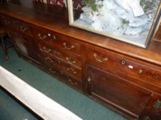 A GEO.III.COUNTRY FRUITWOOD KITCHEN DRESSER WITH FOUR CENTRAL DRAWERS FLANKED BY DRAWERS AND